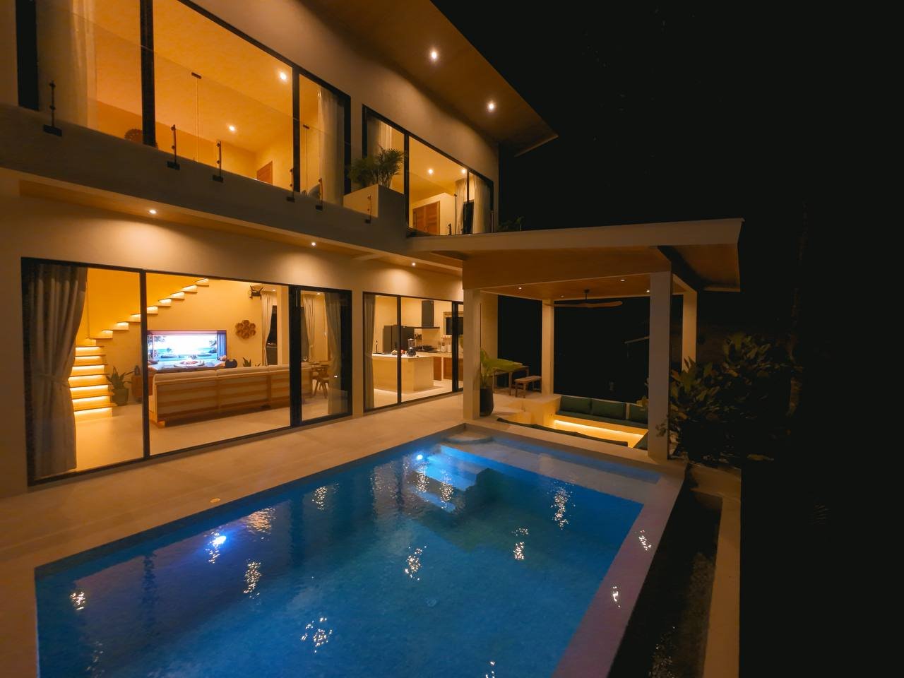 The villa at night, pool lit